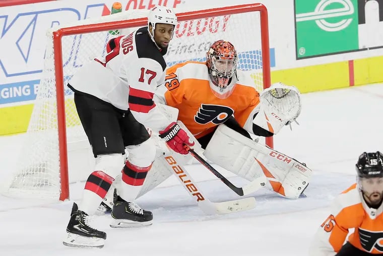 Former Flyer Wayne Simmonds battles in front of goalie Carter Hart during the Flyers' recent 4-0 win over New Jersey. Hart, 21, became the youngest Flyers goalie to ever register a shutout.