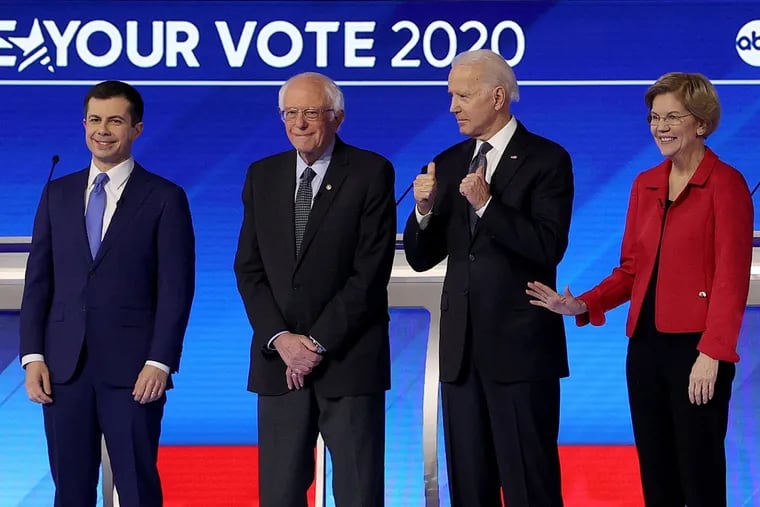 From left, Democratic presidential candidates Pete Buttigieg, Bernie Sanders, Elizabeth Warren, and Joe Biden at a primary debate in the Sullivan Arena at St. Anselm College in Manchester, N.H., on Feb. 7.