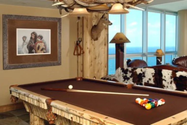 A Mark Rohrig print, &quot;In the Shadow of Giants,&quot; depicting an Indian scene, is a highlight of the saloon-style pool room in the 17th-floor condo.
