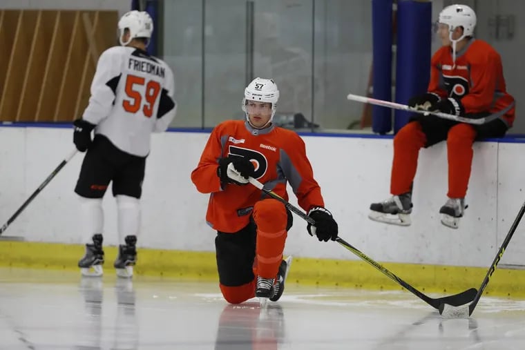 The Flyers’ Travis Sanheim stretches during development camp Saturday.