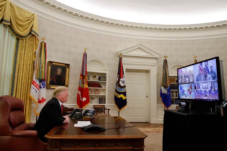 President Donald Trump greets members of the five branches of the military via video conference on Christmas Day, Tuesday, Dec. 25, 2018, in the Oval Office of the White House. The military members were stationed in Guam, Qatar, Alaska, and two in Bahrain.