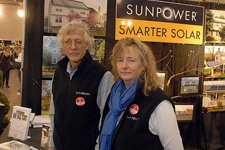 Solar installer Charlie Reichner and wife Catherine Neil staff their booth at the Philadelphia Flower Show. (Ron Tarver/Stafff Photographer)