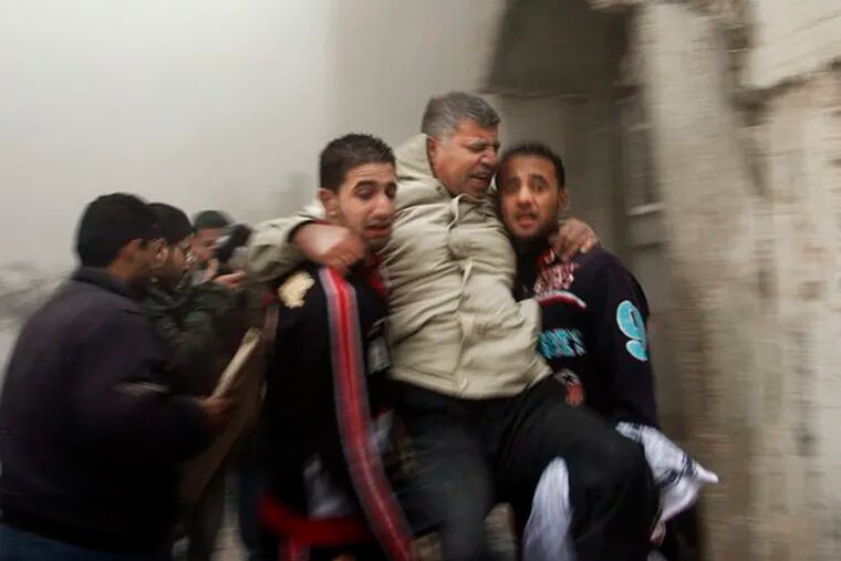 A wounded man is carried to safety after an Israeli missile hit the home of a Hamas member in Beit Lahiya in the northern Gaza Strip. Officials say 364 Palestinians have been killed.