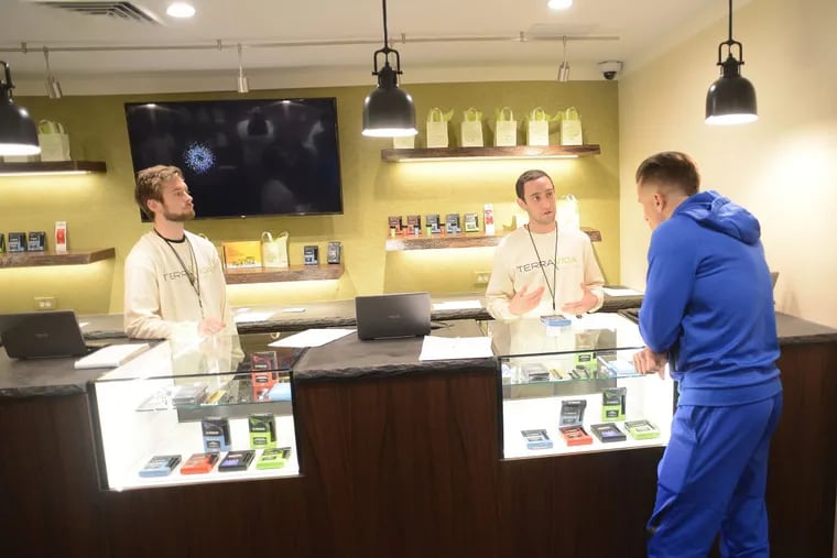 From left, Adam Prowell and Josh Reiss help patient Robert Consulmagno at TerraVida Holistic Center, which is one of the first medical marijuana dispensaries to open in Pennsylvania. (WILLIAM THOMAS CAIN / For The Inquirer)
