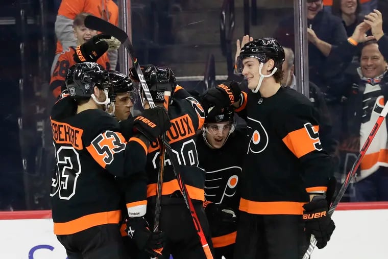 Flyers right wing Travis Konecny (second right) celebrates his first-period goal with his teammates against the Ottawa Senators on Saturday, December 7, 2019 in Philadelphia.