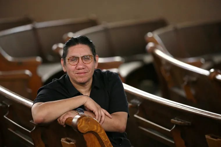 The Rev. Adan A. Mairena of West Kensington Ministry sits for a portrait inside the church's largely unused sanctuary next to Philadelphia's Norris Square on Wednesday, April 8, 2020. Mairena has invited local musicians to perform in the sanctuary while livestreaming it from a safe distance.