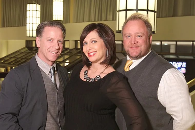 One of the longest-running fundraising parties in Philadelphia, the Hair o' the Dog, celebrates 20 years on Jan. 18. Founders Rob Molinaro,left, and Dan Cronin, right, with their latest organizer addition, Buffy Harakidas at the Sheraton Downtown ballroom on Jan. 9, 2014.  ( CHARLES FOX / Staff Photographer )