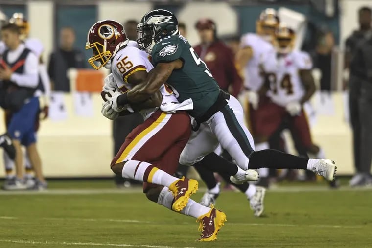 Eagles linebacker Nigel Bradham tackles Washington tight end Vernon Davis during the game at Lincoln Financial Field Oct. 23.