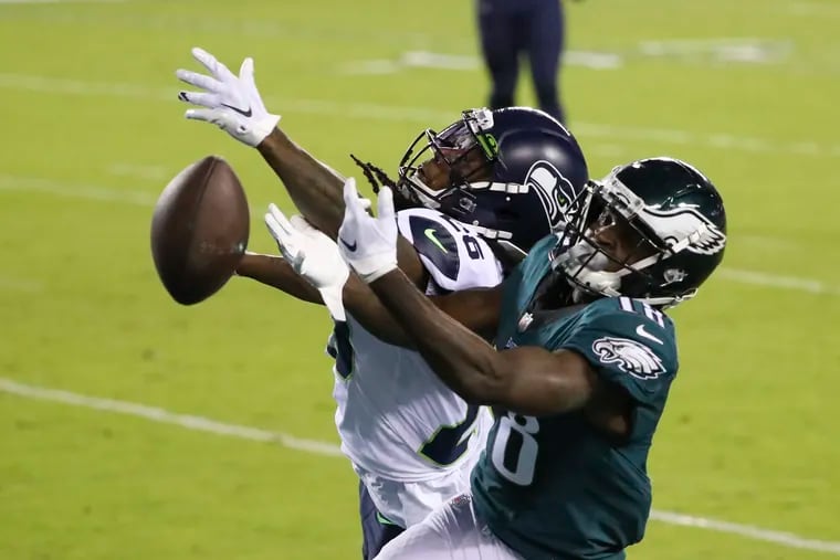 Eagles wide receiver Jalen Reagor attempts to catch the football against Seattle Seahawks cornerback Shaquill Griffin during the fourth quarter on Monday, November 30, 2020.