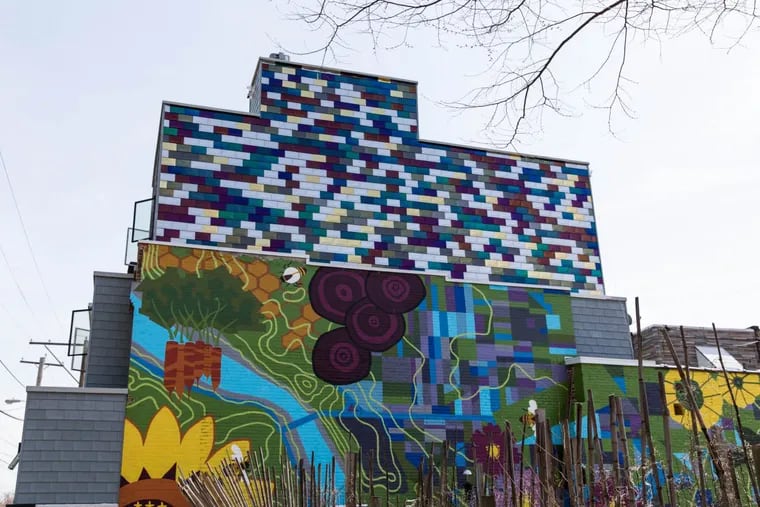 When Robin Riess and Kevin Steckel added a third floor to their rowhouse in Brewerytown, they covered it in vivid 9-by-12-inch stainless steel tiles to complement “The Abundant City” mural on the side of their home.