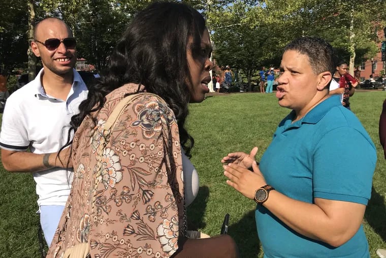 Democratic U.S. Senate candidate Kerri Evelyn Harris speaks to voter Jo Ann Means at Wednesday's Peace on the Streets anti-violence concert in downtown Wilmington.