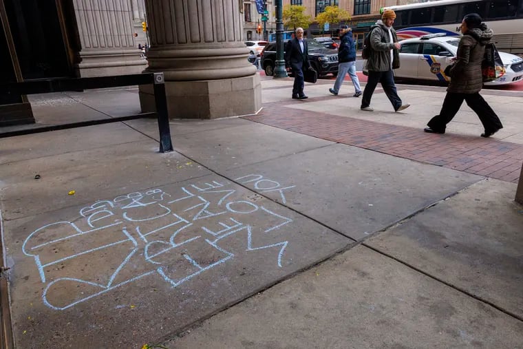 A chalk message dedicated to Eric Harrison, a Macy's loss prevention employee who was killed by an alleged shoplifter on Monday. Debates over poor retail theft policies and penalties mean little to Harrison's loved ones, writes Helen Ubiñas.