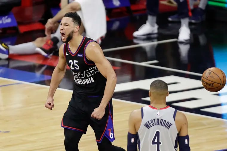 Sixers guard Ben Simmons yells after a put back rebound dunk in the third quarter past Washington Wizards guard Russell Westbrook during Game 1 of the Eastern Conference quarterfinals on Sunday, May 16, 2021.