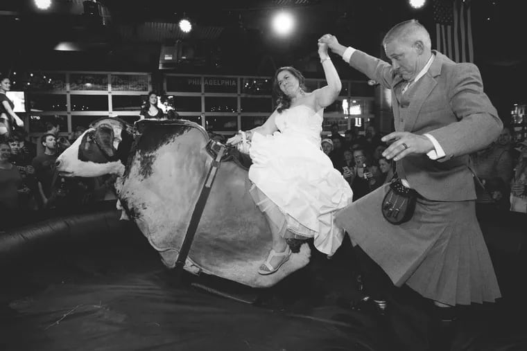 The bride riding the mechanical bull at PBR Bar &amp; Grill at Xfinity Live!