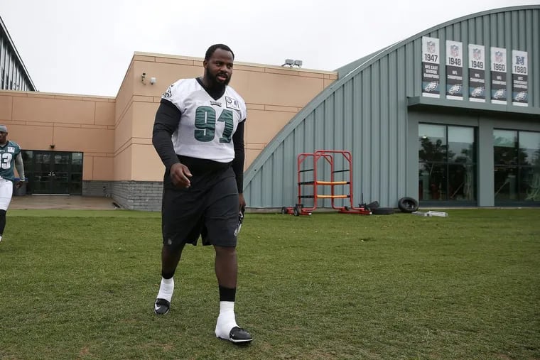 Eagles’ Fletcher Cox heads out to the practice field as the Eagles hold an OTA at the NovaCare Complex on May 30.