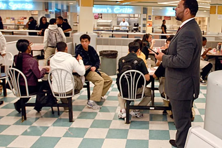 South Philadelphia High School Principal Otis Hackney watches over the school's lunchroom. Hackney is being credited with bringing calm and order to the school. (Ron Tarver / Staff Photographer)