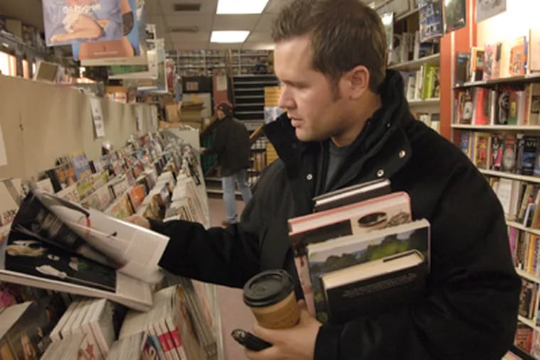 Tim Rizzo, of Philadelphia, looks through magazines at Robin's bookstore on Friday. Rizzo was at the bookstore to take advantage of
the going out of business bargains. (Jonathan Wilson / Staff Photographer)