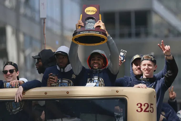 Phil Booth holds up the national championship trophy during Villanova&#039;s NCAA men&#039;s basketball tournament victory parade in Center CIty on Thursday, April 5, 2018. The parade ran from 20th and Market streets to Dilworth Plaza.