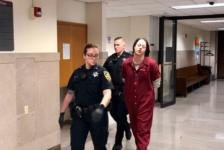 David Moyer is escorted out of a courtroom in the Montgomery County Courthouse after pleading guilty to third-degree murder in his infant son's death.