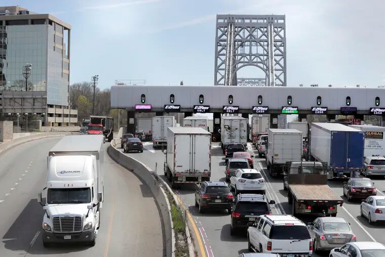 A truck travels westbound off the George Washington Bridge as commuters line up to cross a toll plaza, Wednesday, April 17, 2019, in Fort Lee, N.J. U.S. Reps. Josh Gottheimer and Bill Pascrell held a news conference to announce they plan to fight back against New York City's proposed congestion tax on New Jersey commuters.