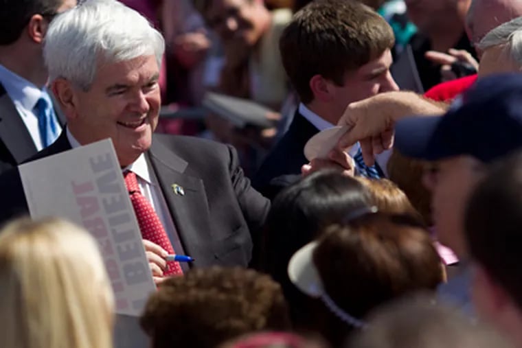 Newt Gingrich works the crowd in Woodstock, in his home state of Georgia, where his presidential campaign needs a victory in Tuesday's primary. (Evan Vucci / Associated Press)