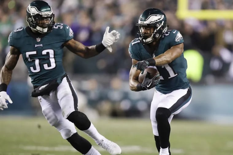 Eagles cornerback Patrick Robinson runs with the football after a first-quarter interception with outside linebacker Nigel Bradham in the NFC Championship game on Sunday, January 21, 2018 in Philadelphia. Robinson scored on the play.