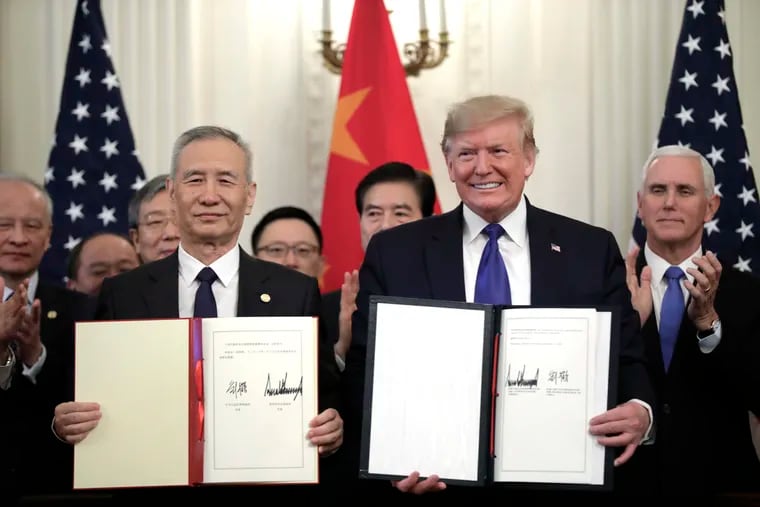 U.S. President Donald Trump and Chinese Vice Premier Liu He sign an initial trade deal at the White House in Washington on January 15, 2020.