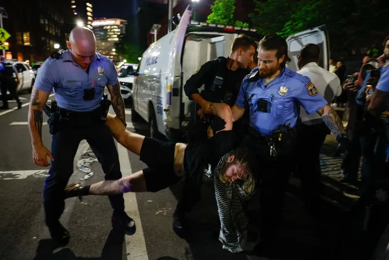 A protester with the Penn Gaza Solidarity Encampment is arrested at South 34th Street near the Penn campus in Philadelphia on Friday, May 17, 2024
