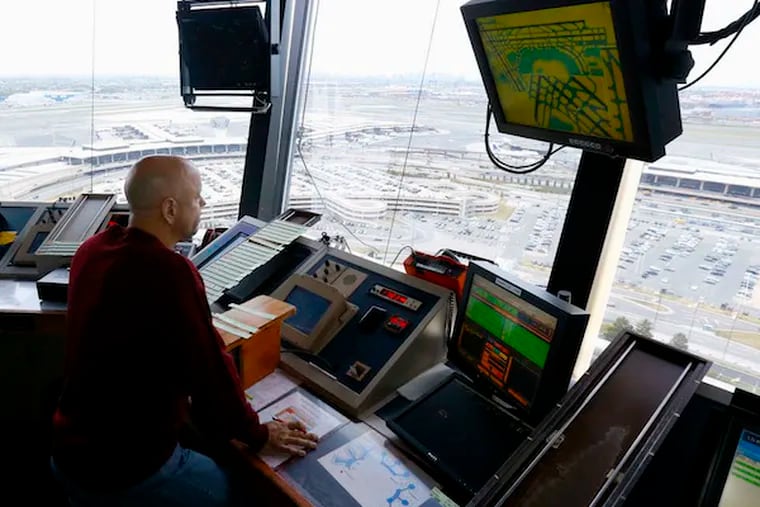 An air traffic controller in the tower at Newark Liberty International Airport. U.S. controllers track 132 million flights annually. (JULIO CORTEZ/AP)