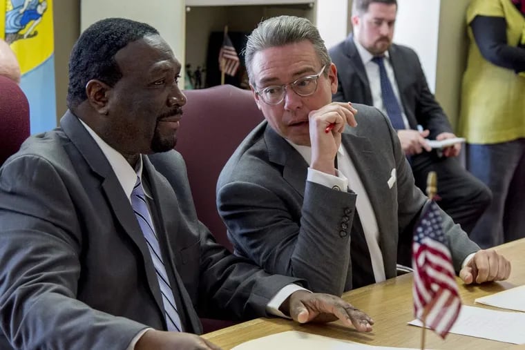 Anthony Clark (left), chairman of the Philadelphia City Commissioners, and Commissioner Al Schmidt confer during a meeting in December.