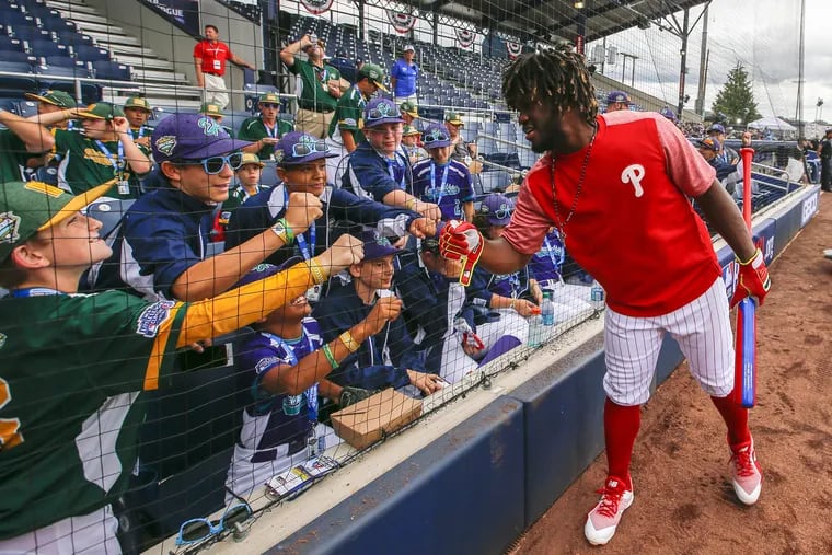 Odubel Herrera meets with Little Leaguers ahead of Sunday's game vs. the Mets, in which he was batting eighth. Manager Gabe Kapler thinks the position can help jumpstart a slumping hitter.