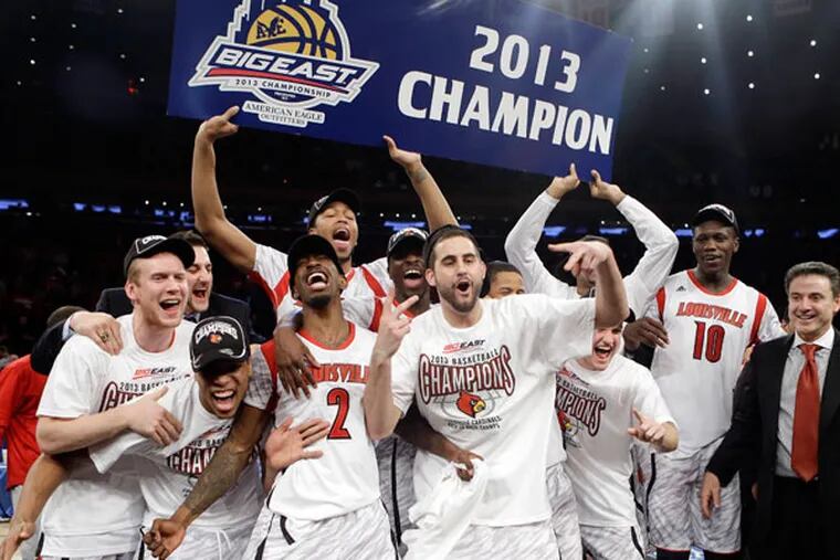 Louisville's Russ Smith (2), Gorgui Dieng (10) and Luke Hancock (center) celebrate with the team after their 78-61 win over Syracuse in an NCAA college basketball championship game at the Big East Conference tournament, Saturday, March 16, 2013, in New York. (Frank Franklin II/AP)