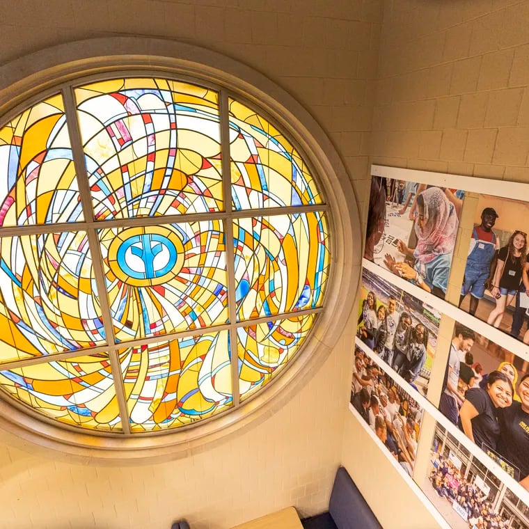 A stained-glass window with an old Cabrini University logo in the center can be seen at the George D. Widener Campus Center at Cabrini University in Radnor.