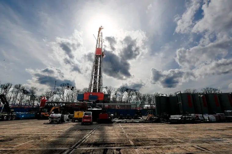 In this March 12, 2020, file photo, the sun shines through clouds above a shale gas drilling site in St. Mary's, Pa. President Donald Trump's administration is expected to undo Obama-era rules designed to limit greenhouse gas emissions from oil and gas fields and pipelines, formalizing the changes in the heart of the nation's most prolific natural gas reservoir and in the premier presidential battleground state of Pennsylvania.