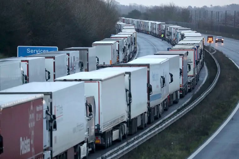 Trucks parked on the M20 in Kent near Folkestone services while the Port of Dover remains closed on Tuesday. France has closed its border with the United Kingdom.