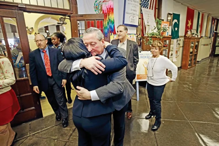 Mayor-elect Jim Kenney gives Lisa Ciaranca Kaplan, Jackson School principal, a hug for letting him use the school to launch his mayoral transition process. Kenney said he would hold town-hall meetings in neighborhoods.