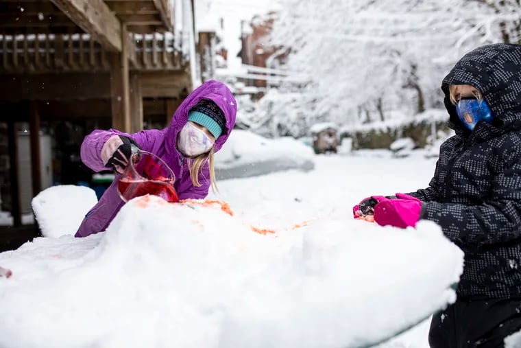 Children play in the snow in Philadelphia in 2021.