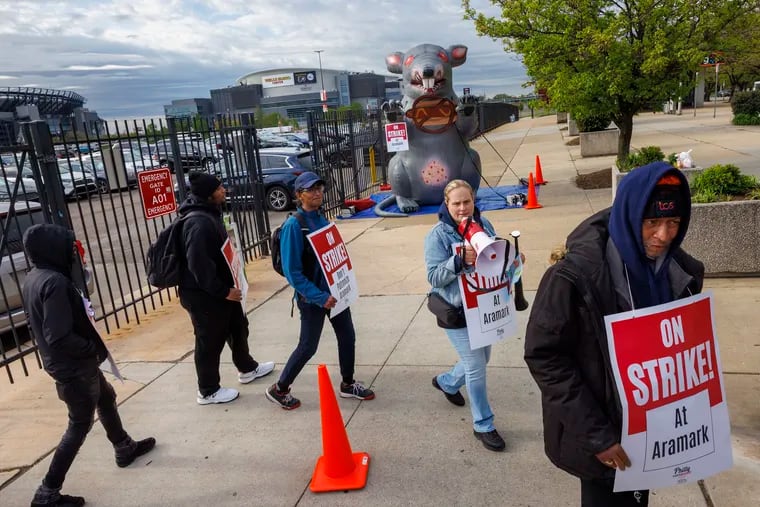 Aramark workers strike outside the Wells Fargo Center before Thursday night's Sixers game.