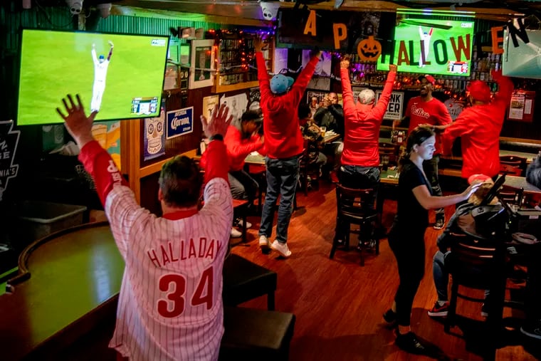 Fans at Chickie & Pete’s in Northeast Philadelphia celebrate the Phillies win over the San Diego Padres in Game 5 of the National League Championship Series.