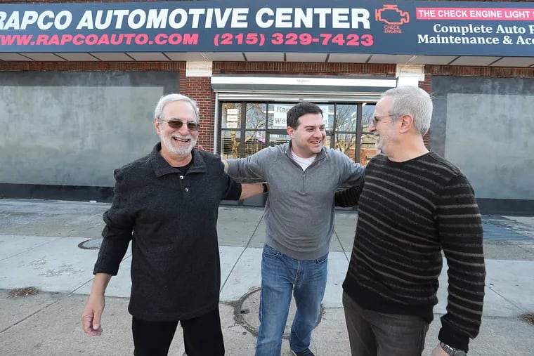 Bruce Goldstein, left, Jason Goldstein, center, and Michael Goldstein, right, pose for a portrait outside their shop, Rapco Automotive Center, in Philadelphia, PA on November 21, 2019. They renovated the exterior of the shop. The work was part of the City of Philadelphia’s program called the "Storefront Improvement Program.”
