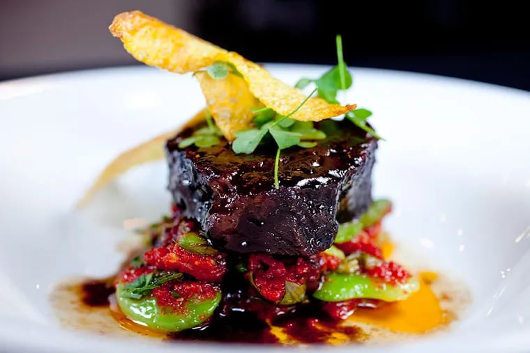 Slow-cooked beef cheek, meltingly tender over lima beans, heirloom tomato, sorrel, and saffron potato chips.