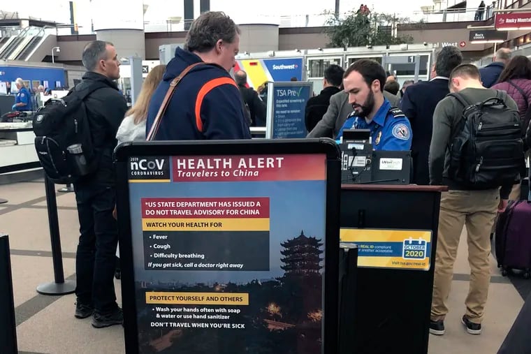 A health alert for people traveling to China at a TSA security checkpoint at the Denver International Airport on March 2.