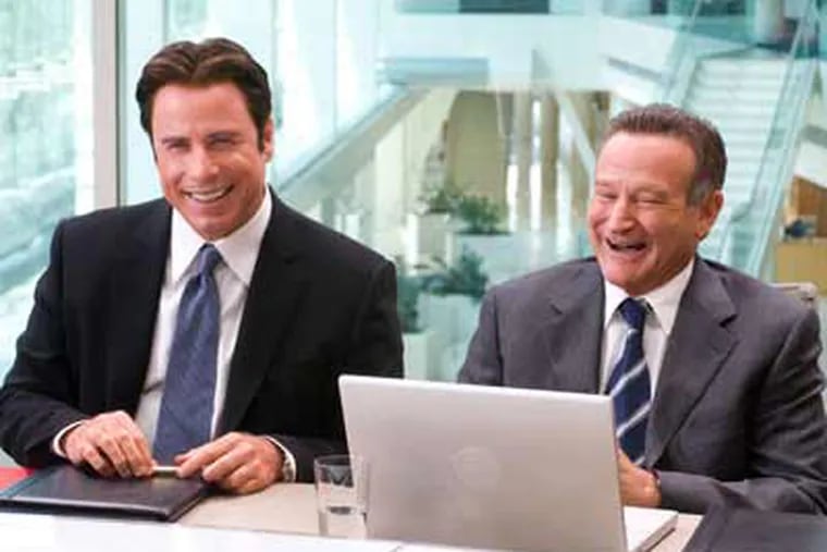 In this film publicity image, John Travolta, left, and Robin Williams are shown in a scene from the film "Old Dogs." (AP Photo/Disney, Ron Phillips)