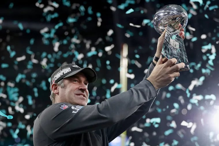 Eagles head coach Doug Pederson hoists the Lombardi Trophy during the postgame ceremony.