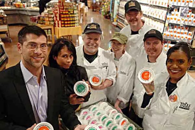 Robert Katz (far left) and Ivette Cortez (second from left) of Bobbi's Hummus pose with Whole Foods employees at the South Street store, where their product can be purchased.  February 25, 2009  (Sarah J. Glover / Staff Photographer)