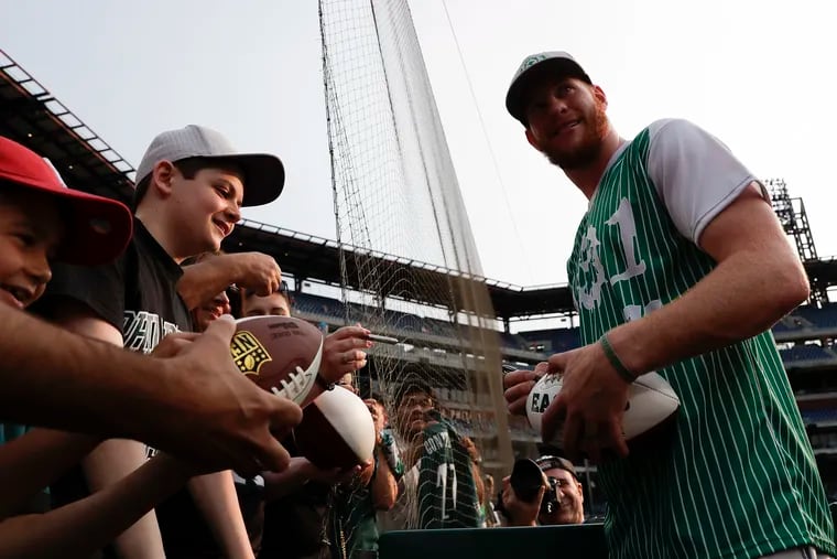 Eagles quarterback Carson Wentz signs his autograph for fans before the start of his charity softball game at Citizens Bank Park on Friday, May 31, 2019.