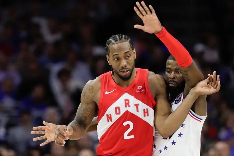 Sixers forward James Ennis III defends Toronto Raptors forward Kawhi Leonard during the third-quarter in game six of the Eastern Conference playoff semifinals on Thursday, May 9, 2019 in Philadelphia.