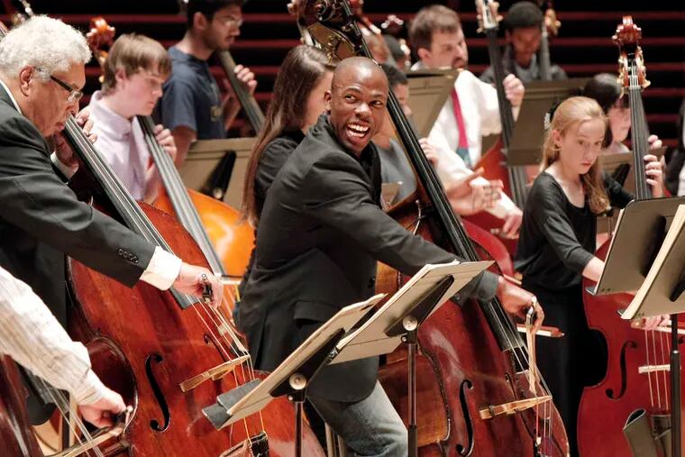 Orchestra assistant principal bass Joseph Conyers enjoys the double-bass play-in at the Kimmel Center's Commonwealth Plaza.