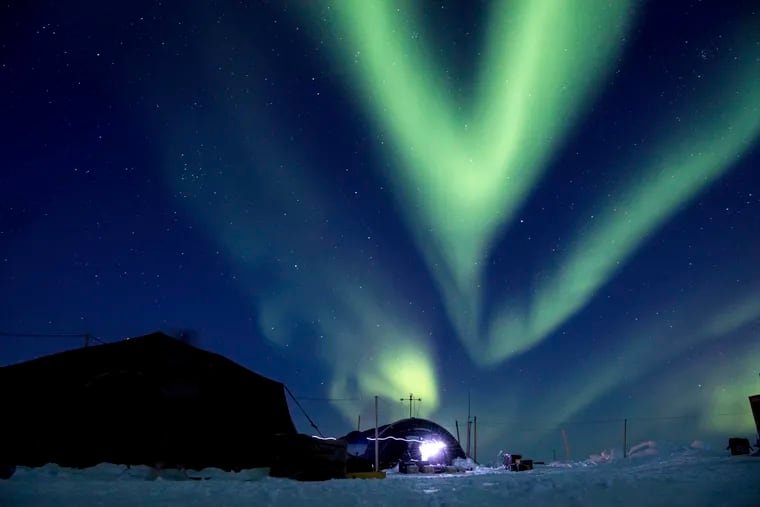 FILE - In this March 9, 2018, file photo provided by the U.S. Navy, the aurora borealis displays above Ice Camp Skate in the Beaufort Sea during Ice Exercise (ICEX) 2018. Scientists are seeing surprising melting in Earth's polar regions at times they don't expect, like winter, and in places they don't expect, like eastern Antarctica. (MC 2nd Class Micheal H. Lee/U.S. Navy via AP, File)