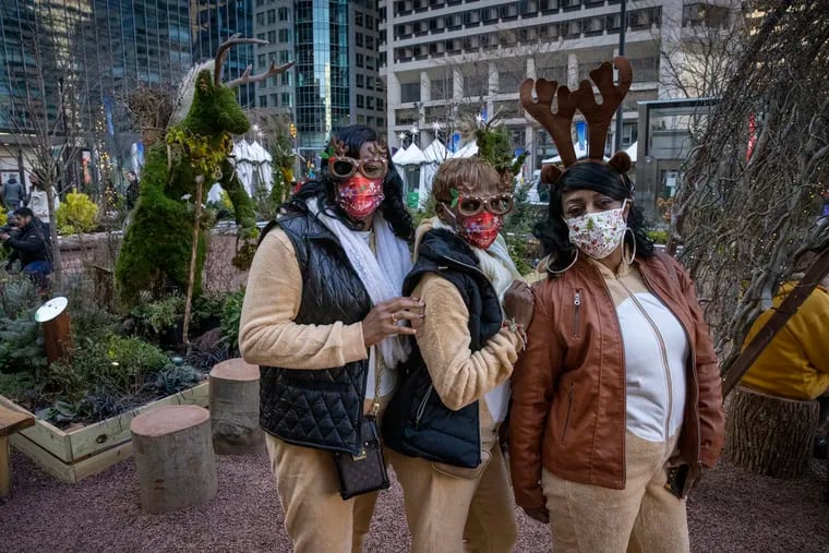 Joan Jones (from left to right), Carla Lowe and Kasima Bond go out in seasonal costumes as a Christmas Eve tradition. This year, the resurgent pandemic is weighing on their mood.